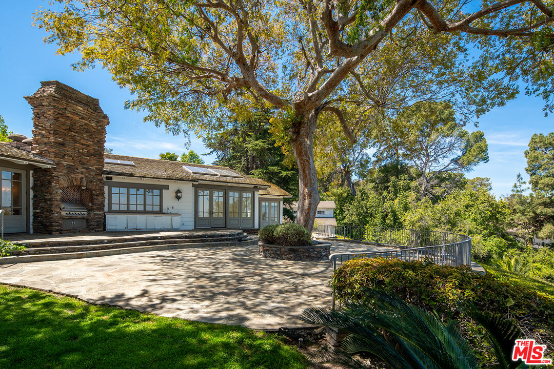 74 Saddleback Road Rolling Hills, CA 90274 - Photo 52 of 65 a front view of a house with a yard and trees