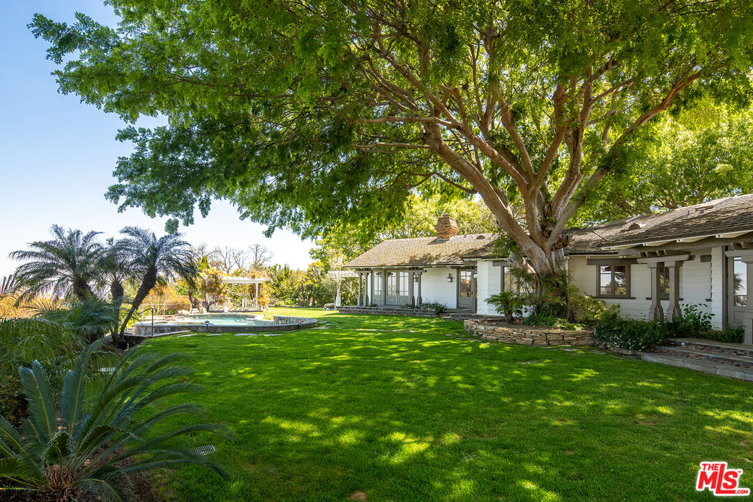 74 Saddleback Road Rolling Hills, CA 90274 - Photo 54 of 65 a backyard of a house with table and chairs