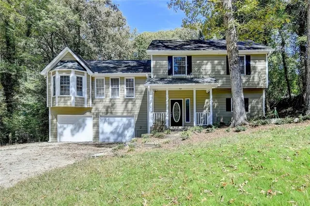 a front view of a house with a yard