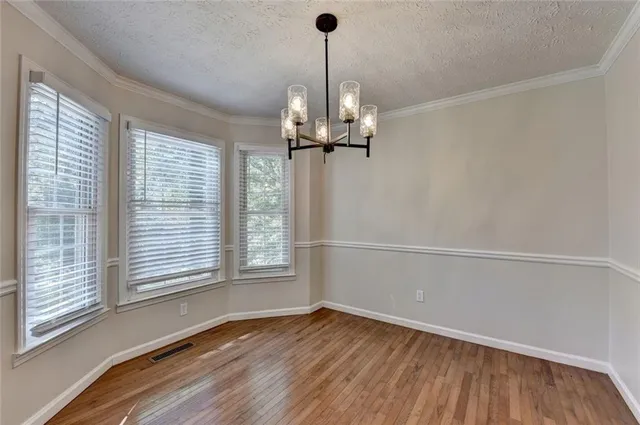 a kitchen with stainless steel appliances granite countertop a sink stove and wooden cabinets