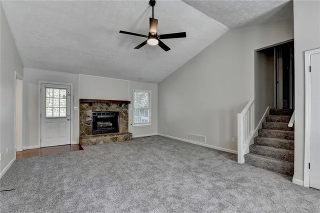 a view of empty room with a ceiling fan and window