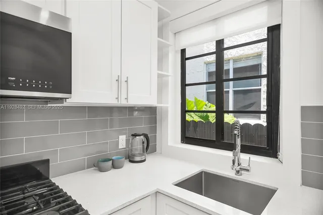 a kitchen with a sink and a window