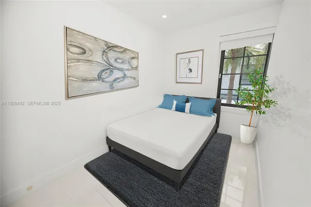 a bedroom with a bed and painting on the wall