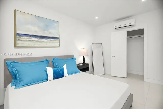 a bedroom with a bed and a painting on the wall