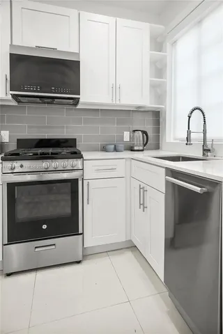 a kitchen with a stove top oven and cabinets