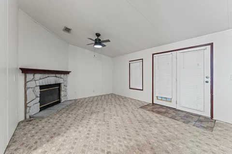 a view of empty room with a fireplace