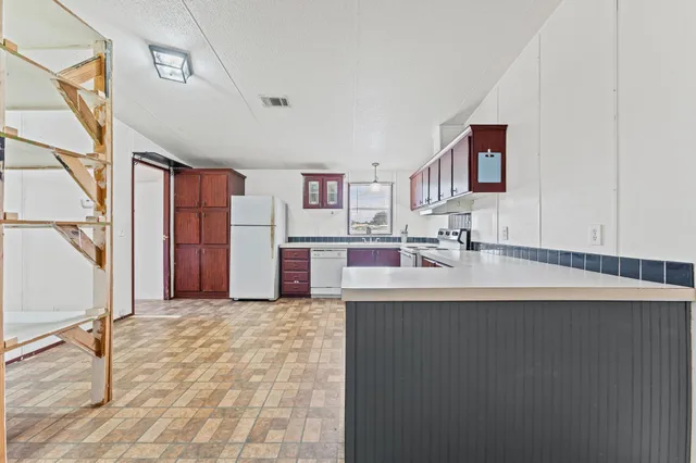 a kitchen with stainless steel appliances a sink stove and cabinets