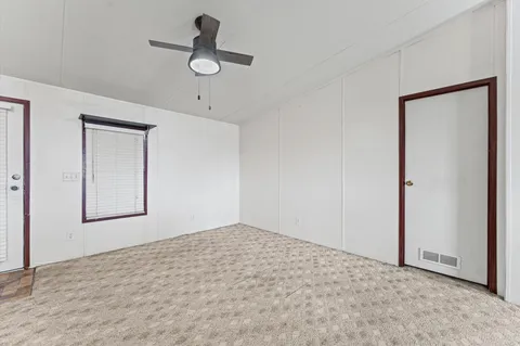 a view of empty room with ceiling fan