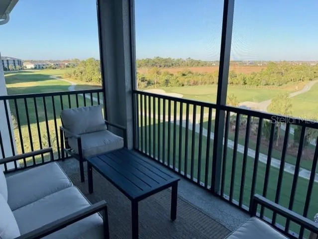 a view of a balcony with wooden floor