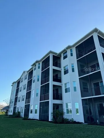 a view of a large building with a yard