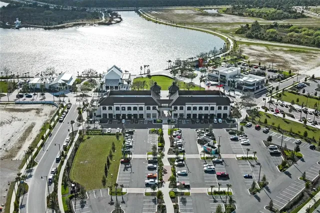 an aerial view of a house with a garden and lake view