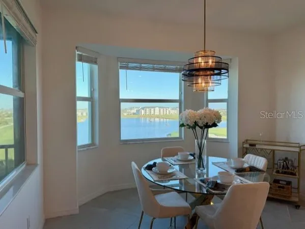 a view of a dining room with furniture wooden floor and chandelier
