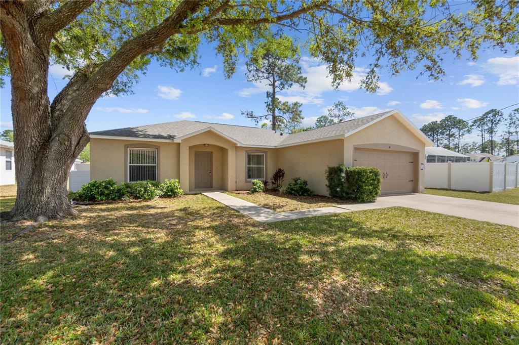 31 Pillar Lane Palm Coast, FL 32164 - Photo 1 of 1 a front view of a house with a garden