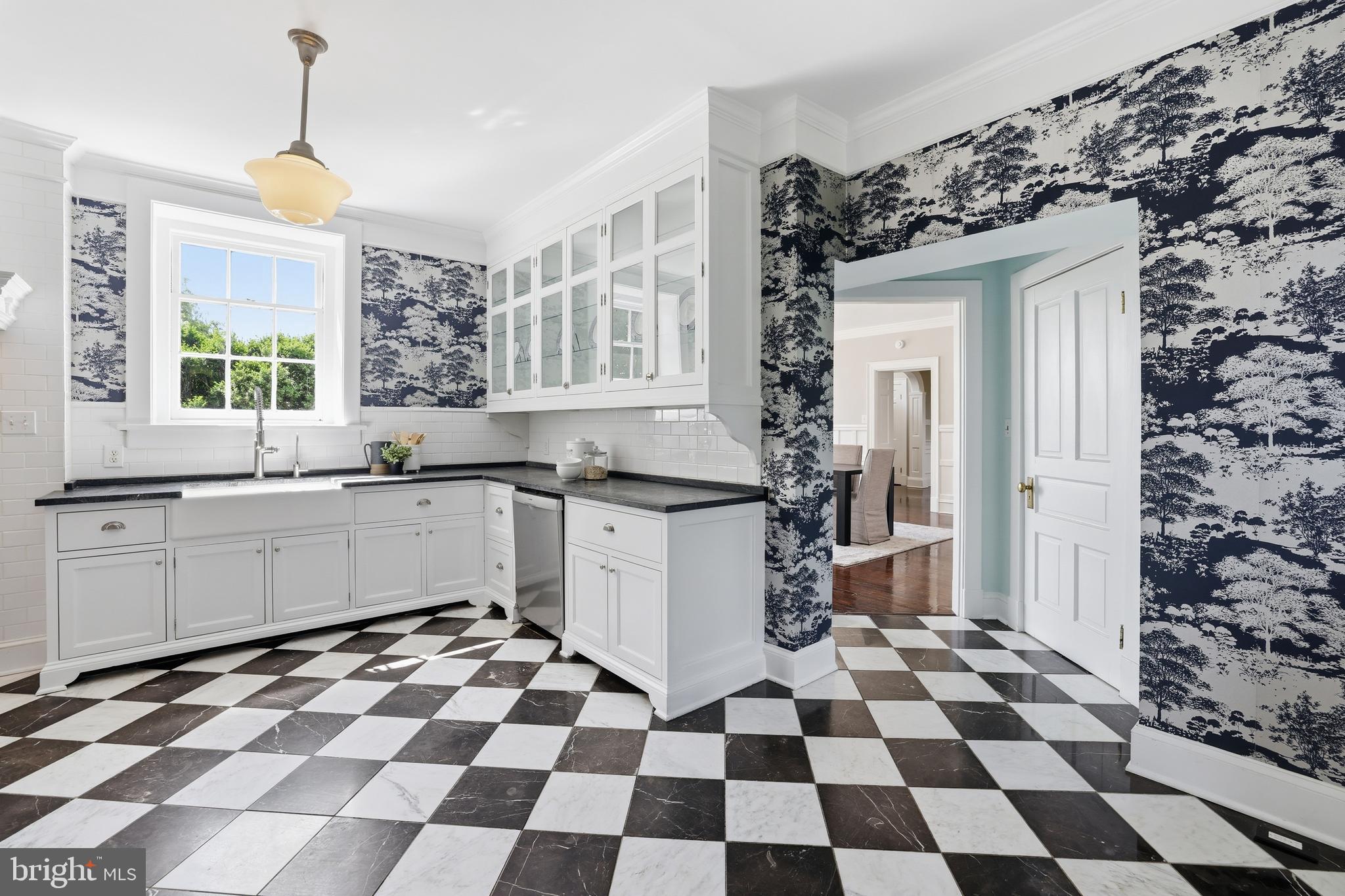 17781 Roxbury Hall Road Leesburg, VA 20175 - Photo 21 of 107 a kitchen with a checkered floor and white cabinets