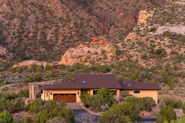 an aerial view of house with yard and car parked