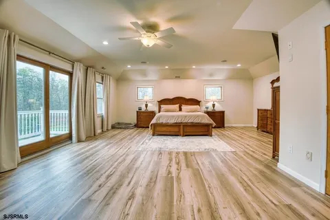 a bedroom with a large bed and a window