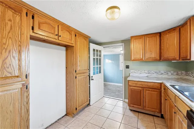 a kitchen with stainless steel appliances granite countertop a sink stove and cabinets