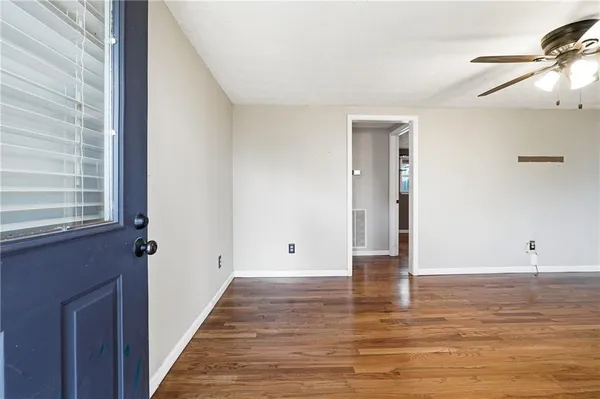 wooden floor in an empty room with a window