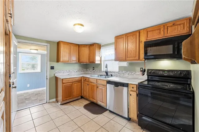 a kitchen with a refrigerator a sink and cabinets