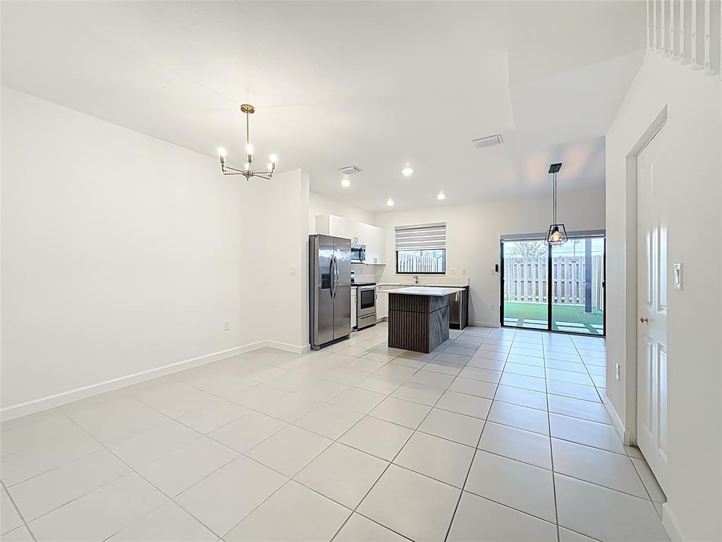 23513 Southwest 127th Place Homestead, FL 33032 - Photo 12 of 43 a large white kitchen with a cabinetry