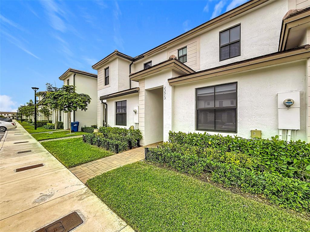 23513 Southwest 127th Place Homestead, FL 33032 - Photo 4 of 43 a front view of a house with a yard