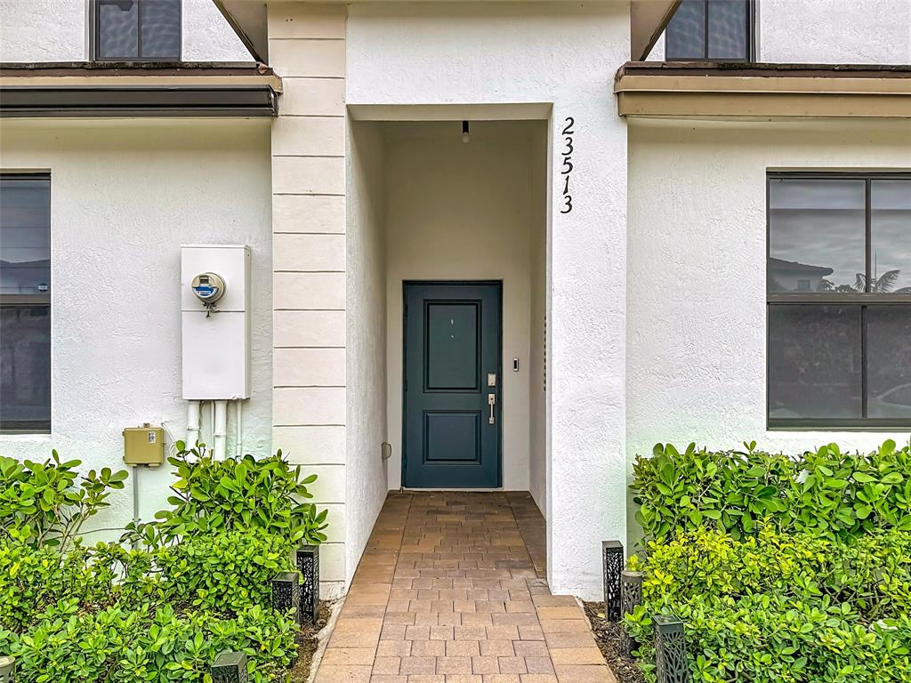 23513 Southwest 127th Place Homestead, FL 33032 - Photo 9 of 43 a front view of a house with a garden