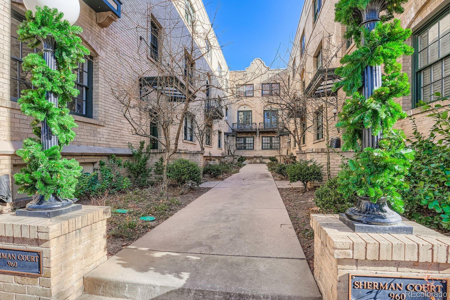960 Sherman Street, Unit 1B Denver, CO 80203 - Photo 1 of 25 a view of a building with a yard and potted plants