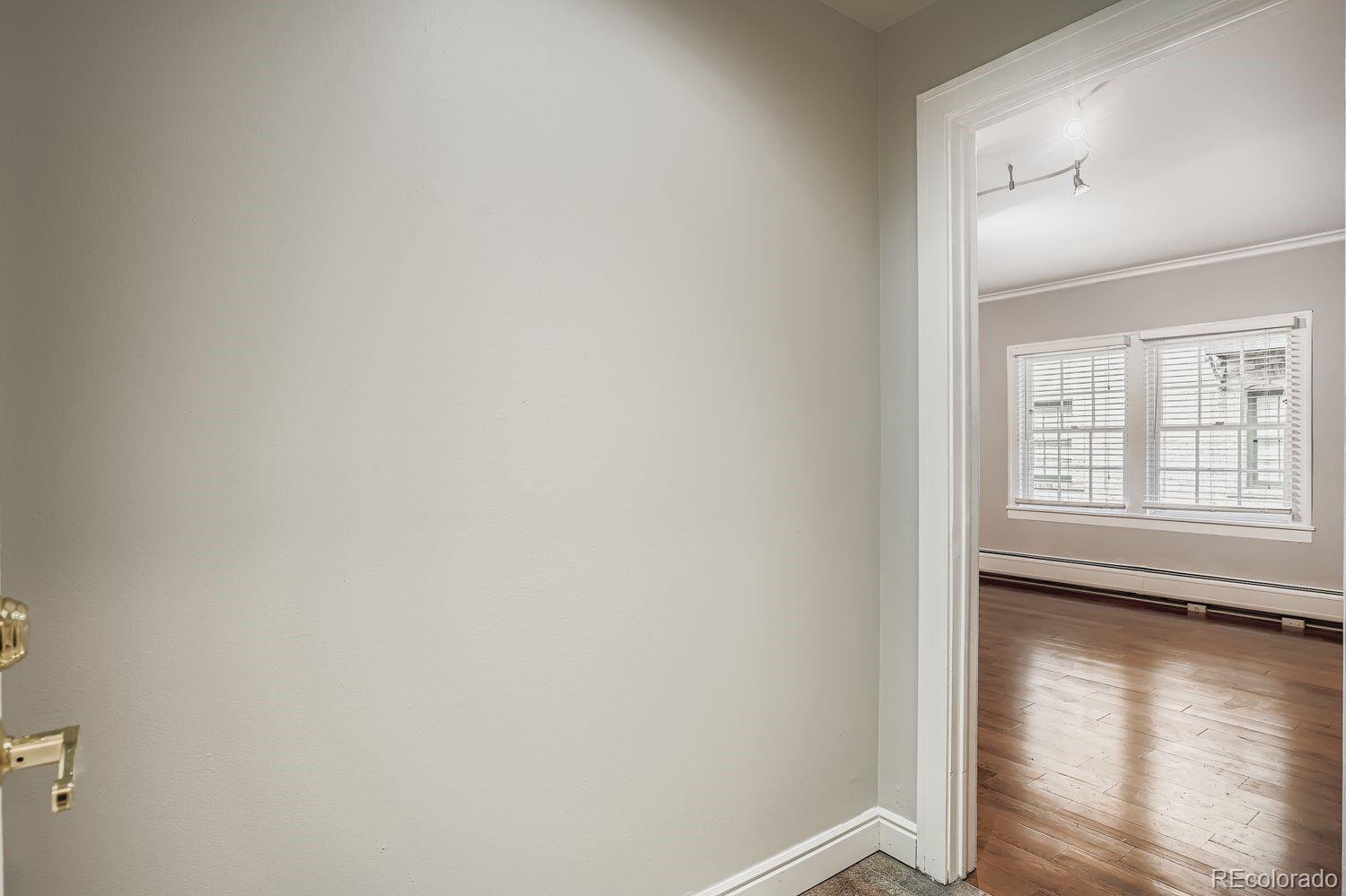 960 Sherman Street, Unit 1B Denver, CO 80203 - Photo 13 of 25 a view of empty room with wooden floor and fan