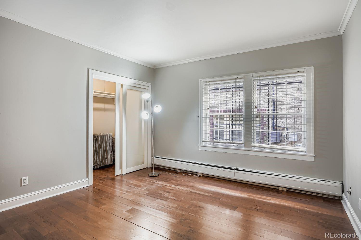 960 Sherman Street, Unit 1B Denver, CO 80203 - Photo 16 of 25 an empty room with wooden floor and windows