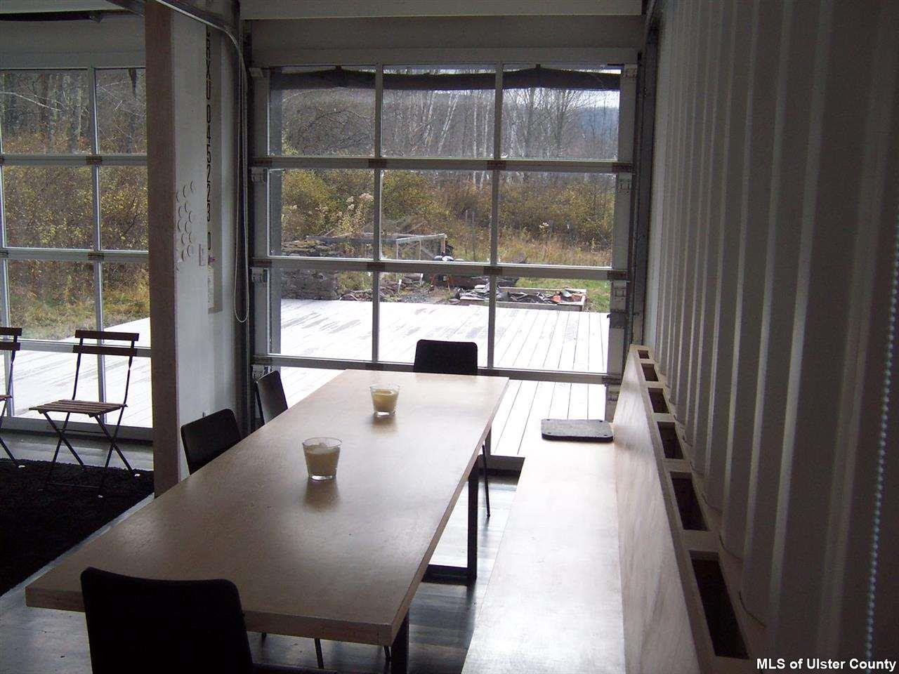 4896 Vega Mountain Road Roxbury, NY 12474 - Photo 9 of 14 a view of a dining room with furniture wooden floor and a potted plant