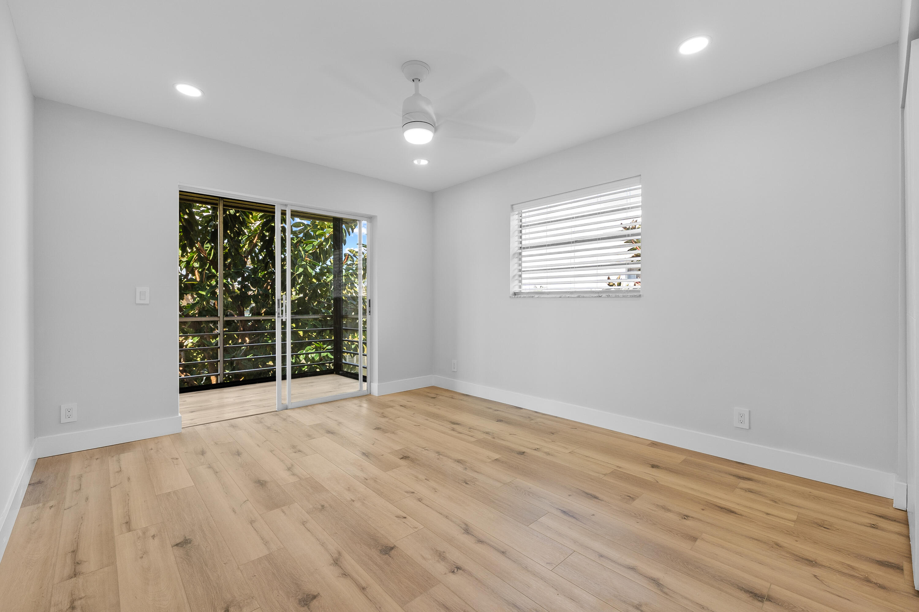 314 Monaco Boulevard, Unit G Delray Beach, FL 33446 - Photo 16 of 26 an empty room with wooden floor and windows