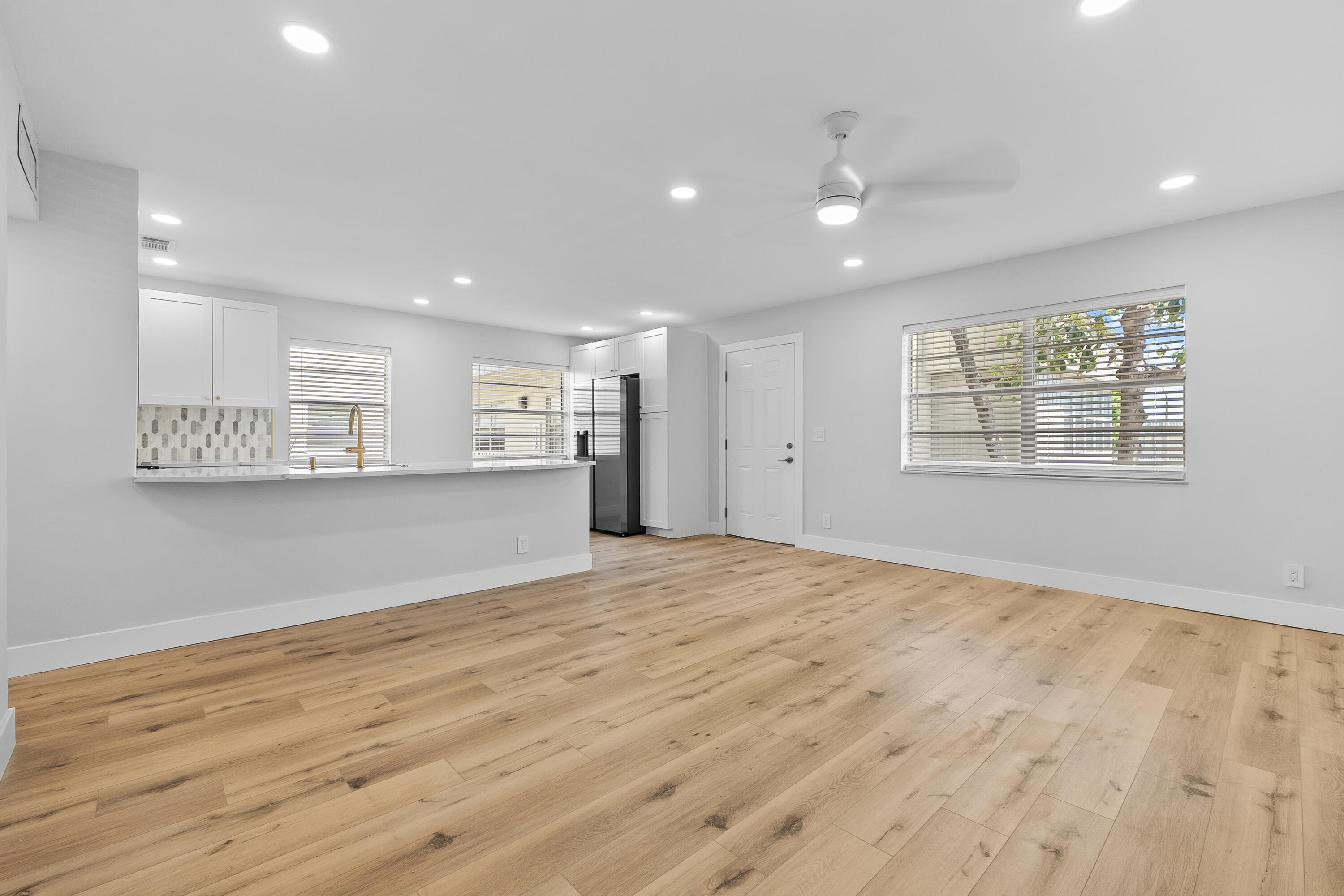 314 Monaco Boulevard, Unit G Delray Beach, FL 33446 - Photo 2 of 26 a view of an empty room with wooden floor and a window