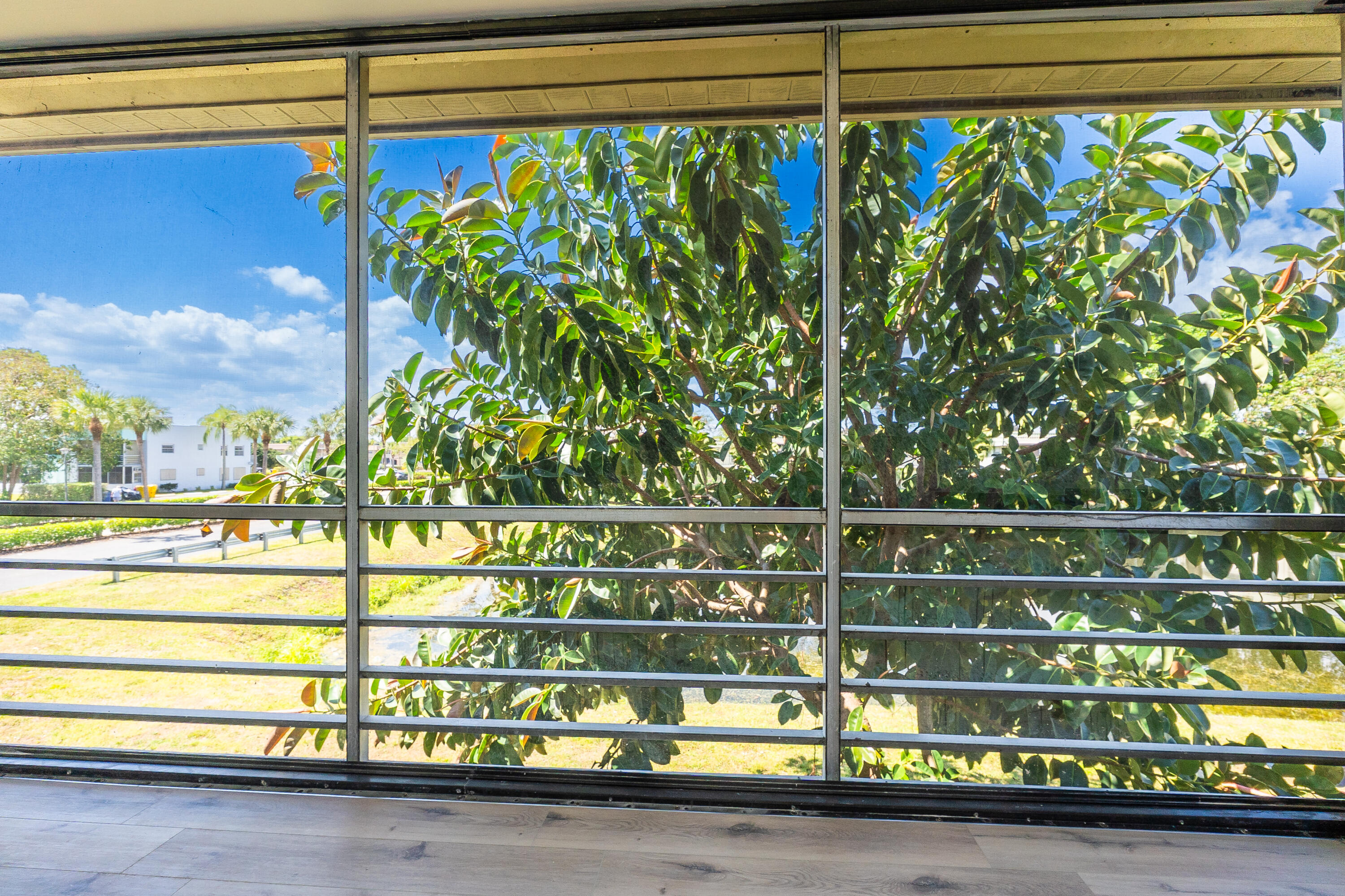 314 Monaco Boulevard, Unit G Delray Beach, FL 33446 - Photo 24 of 26 a view of a street with cars parked