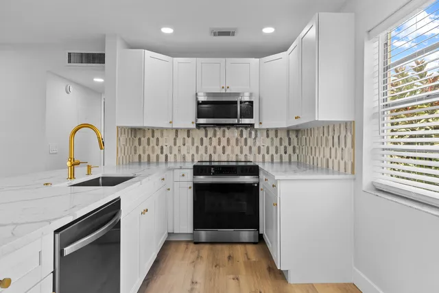 a view of a refrigerator in kitchen and wooden floor