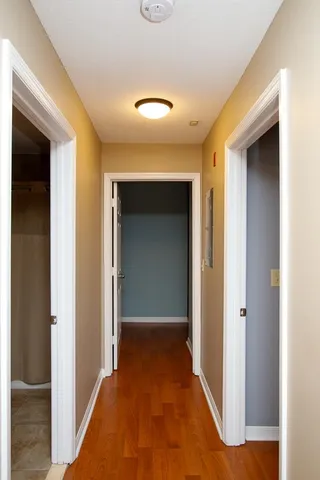 a view of a hallway with wooden shelves