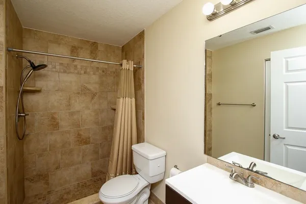 a bathroom with a sink toilet and shower
