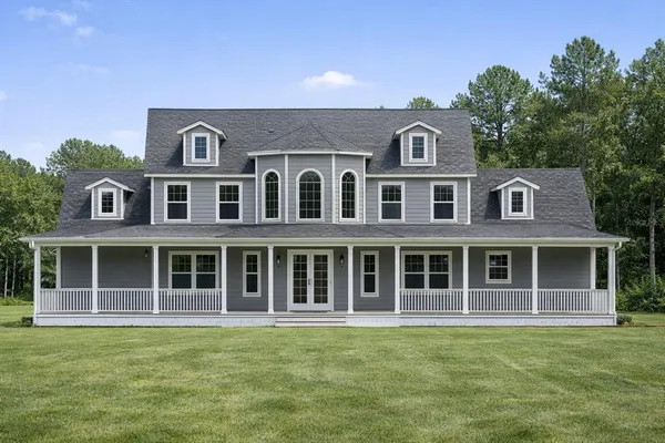 a front view of a house with a garden