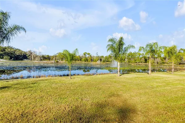 a view of a lake with houses in the background