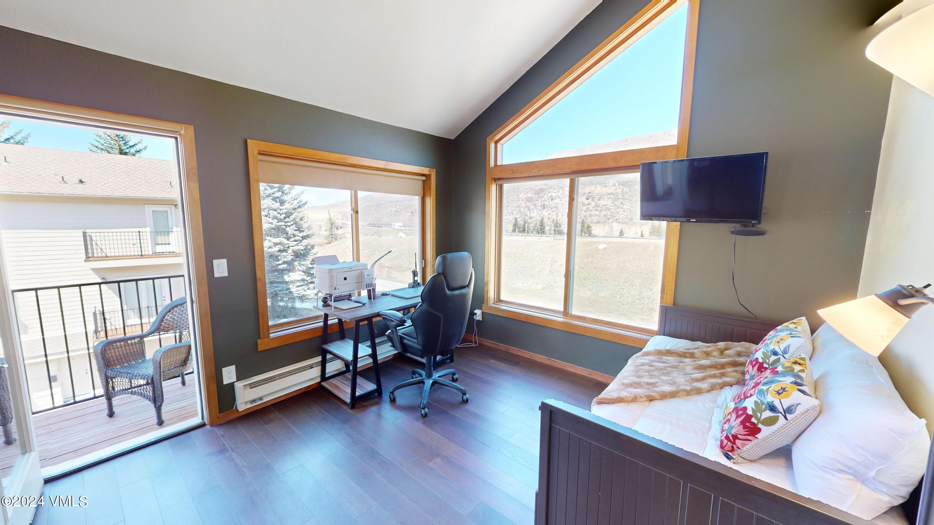 314 Eagle Road, Unit B1 Avon, CO 81620 - Photo 13 of 24 a bedroom with furniture and a large window