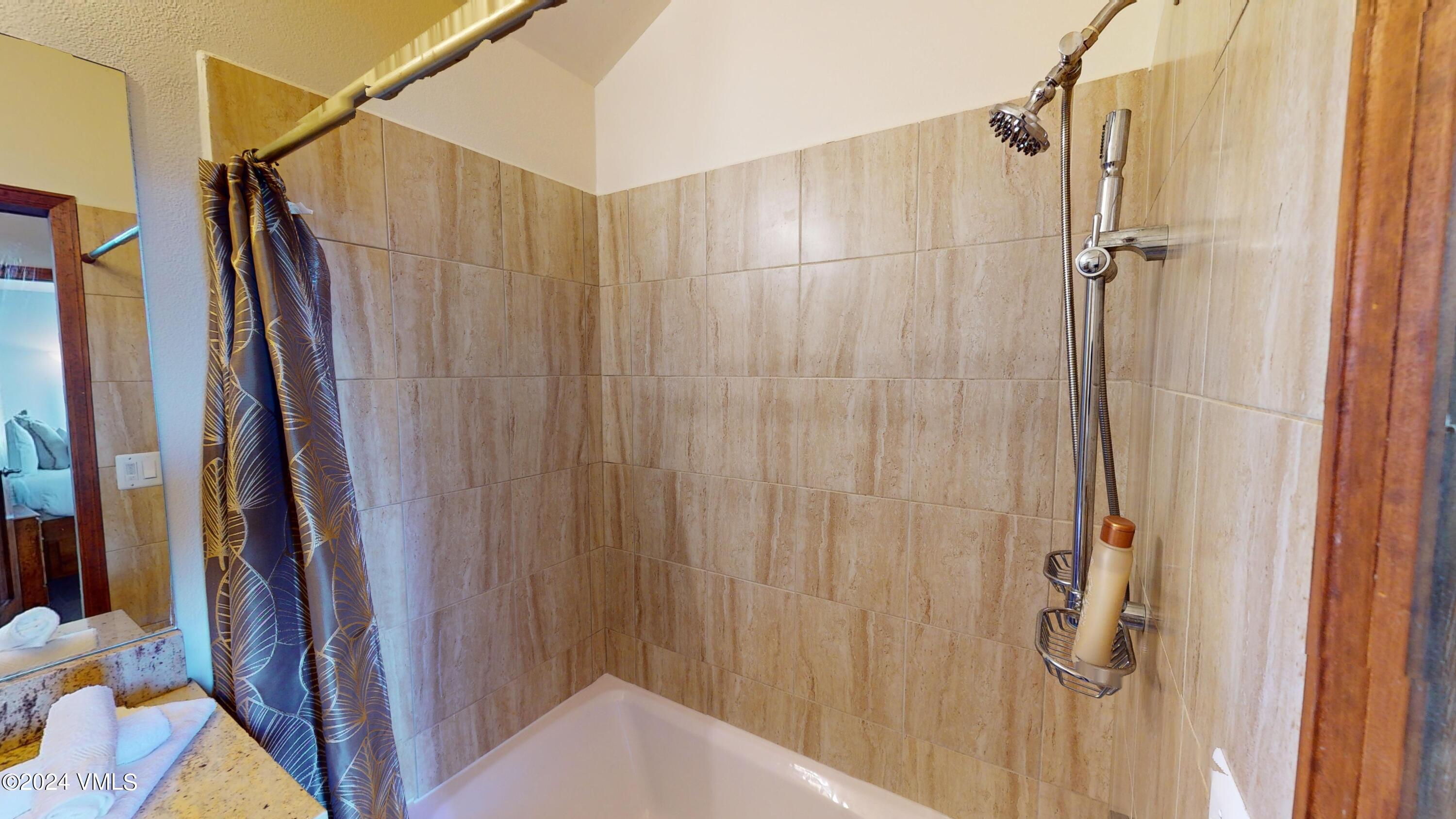 314 Eagle Road, Unit B1 Avon, CO 81620 - Photo 14 of 24 a bathroom with a shower and a tub