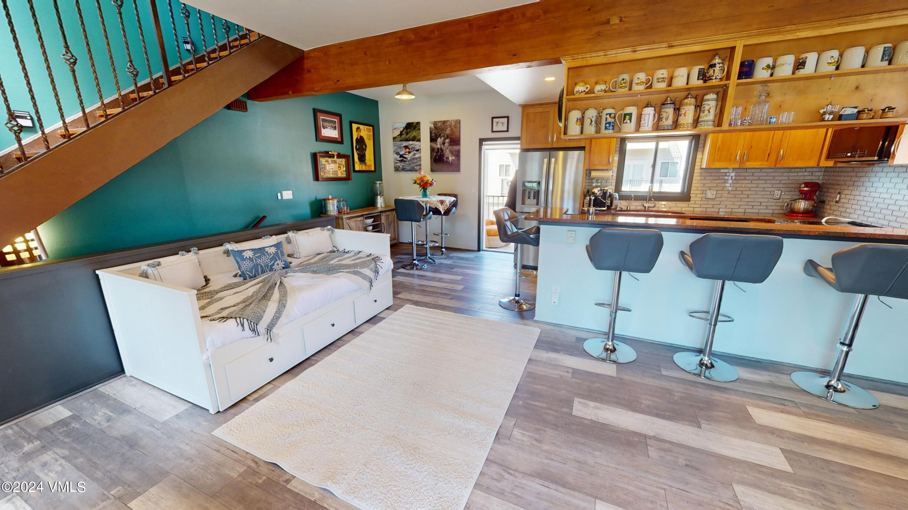 314 Eagle Road, Unit B1 Avon, CO 81620 - Photo 6 of 24 a view of a patio with couches table and chairs with wooden floor
