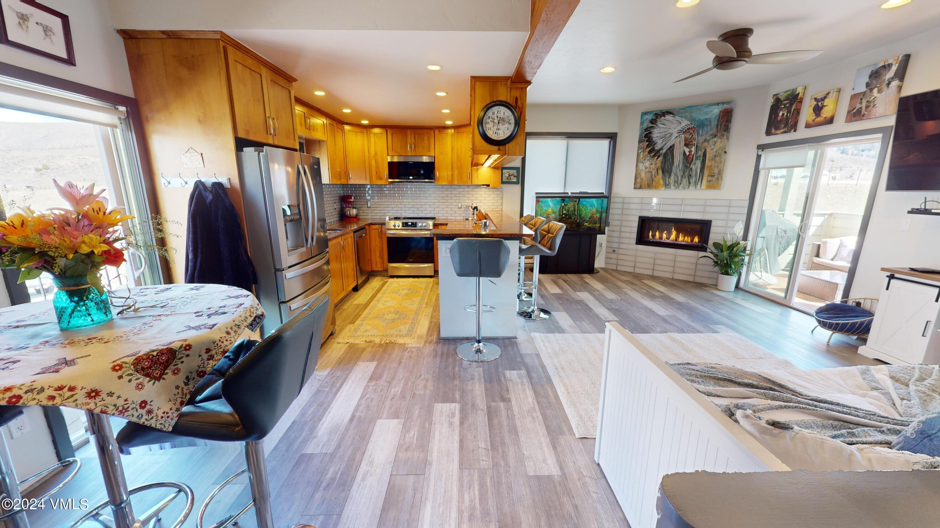 314 Eagle Road, Unit B1 Avon, CO 81620 - Photo 7 of 24 a living room with stainless steel appliances furniture a fireplace and a kitchen view