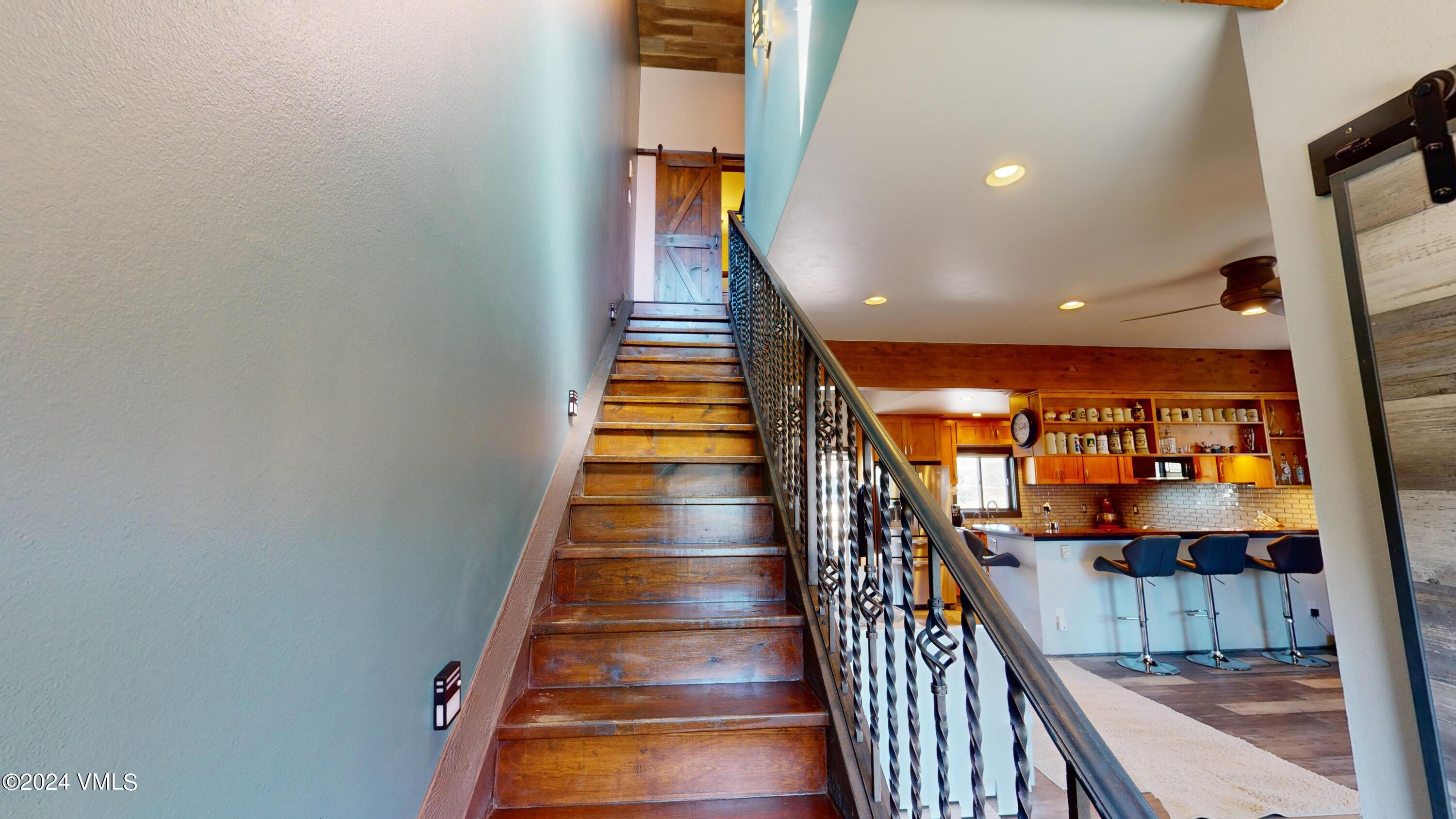314 Eagle Road, Unit B1 Avon, CO 81620 - Photo 8 of 24 a view of staircase with wooden floor and white walls