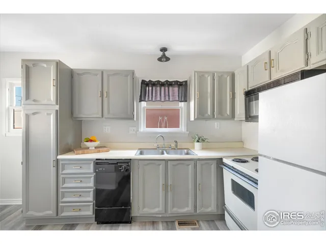 a kitchen with a sink stove and refrigerator