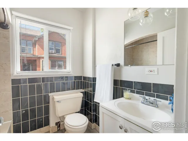 a bathroom with a toilet a sink and a mirror