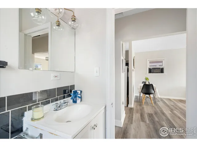 a bathroom with a sink a mirror and vanity