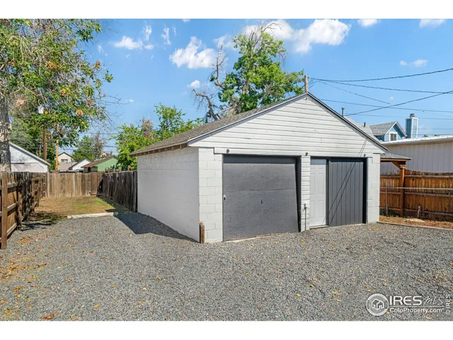 a view of a house with a backyard and garage