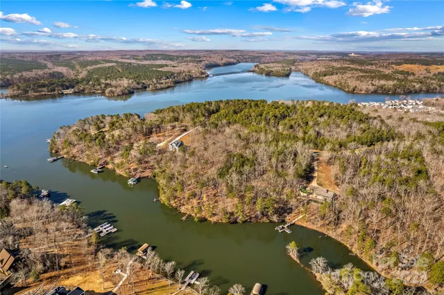 a front view of a house with a garden and trees