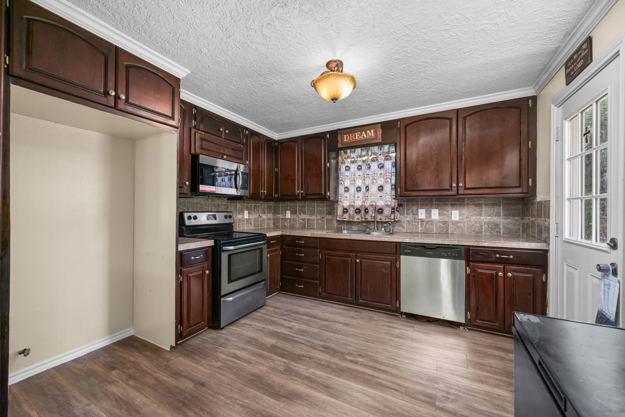 1814 Mansfield Street Houston, TX 77091 - Photo 12 of 29 a kitchen with stainless steel appliances granite countertop a stove a sink and a microwave