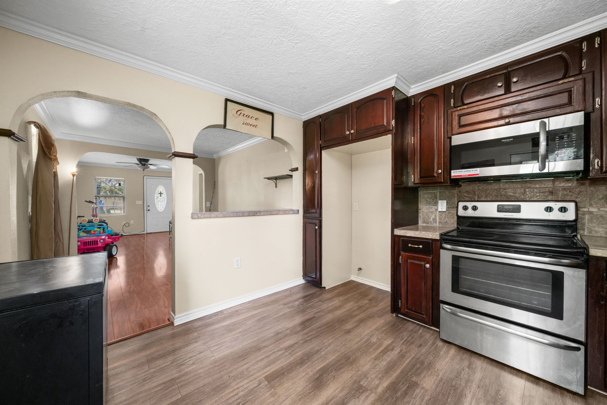 1814 Mansfield Street Houston, TX 77091 - Photo 13 of 29 a kitchen with wooden floor and stainless steel appliances